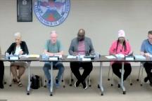 Five people sitting at a table